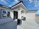 The front entry has stone accents and modern exterior lighting at 2700 W Carnation Way, Pahrump, NV 89048