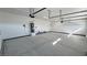 Bright three-car garage featuring sealed concrete flooring, storage, and automatic door openers at 2700 W Carnation Way, Pahrump, NV 89048