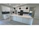 Spacious kitchen with white cabinetry, black hardware, and a large central island at 2700 W Carnation Way, Pahrump, NV 89048