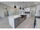 Modern kitchen with a large quartz island, stainless steel appliances, and an open layout to the living area at 2700 W Carnation Way, Pahrump, NV 89048