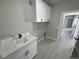 Clean and organized laundry room featuring white cabinetry and modern fixtures at 2700 W Carnation Way, Pahrump, NV 89048