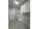 Well-lit laundry room featuring white cabinets, sink, and modern appliances at 2700 W Carnation Way, Pahrump, NV 89048