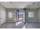 Bright living room with a modern front door and mountain views, complete with gray wood-look floors at 2700 W Carnation Way, Pahrump, NV 89048