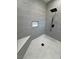 Modern shower with gray tile, bench seating, and a sleek showerhead; a spa-like retreat at 2700 W Carnation Way, Pahrump, NV 89048