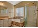 Bathroom with tub shower combo, vanity, and large mirror at 2721 Tahiti Isle Ave, North Las Vegas, NV 89031