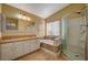 Bathroom with double vanity, soaking tub, and separate shower at 2721 Tahiti Isle Ave, North Las Vegas, NV 89031