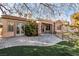 Spacious backyard with stone patio, lawn, and covered patio, perfect for outdoor entertaining at 2794 Evening Rock St, Las Vegas, NV 89135