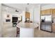 Open kitchen with light wood cabinets, a stainless fridge and tile flooring, seamlessly flowing into the living space at 2794 Evening Rock St, Las Vegas, NV 89135