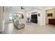 Bright living room with tile floors, fireplace, ceiling fan, and views to the balcony at 2794 Evening Rock St, Las Vegas, NV 89135