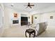 Bright living room featuring a fireplace, neutral walls, tile floors and a comfortable seating area at 2794 Evening Rock St, Las Vegas, NV 89135