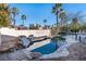 Backyard pool showcasing rock waterfall feature, landscaping, and privacy wall at 2794 Evening Rock St, Las Vegas, NV 89135