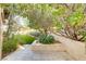 Landscaped backyard featuring manicured lawn and decorative stone planter in a serene setting at 308 Bayswater Ct, Las Vegas, NV 89145