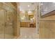 Elegant bathroom showcasing a glass shower, a vanity with storage, and a large mirror at 308 Bayswater Ct, Las Vegas, NV 89145