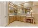 Bathroom featuring a double sink vanity with granite countertops, decorative lighting, and ample storage at 308 Bayswater Ct, Las Vegas, NV 89145