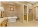 Elegant bathroom showcasing a soaking tub, double sink vanity, decorative lighting and ample storage at 308 Bayswater Ct, Las Vegas, NV 89145