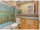 Bathroom featuring a glass shower, tile walls, toilet, and vanity with storage in a neutral color palette at 308 Bayswater Ct, Las Vegas, NV 89145