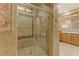 Bathroom featuring a glass shower, tile walls with decorative accents, and a vanity with ample counter space at 308 Bayswater Ct, Las Vegas, NV 89145