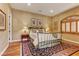 Cozy bedroom featuring hardwood floors, a queen-sized bed, and plantation shutters allowing for natural light at 308 Bayswater Ct, Las Vegas, NV 89145