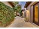 Tranquil courtyard with stone pathway, lush greenery, and elegant outdoor seating creating a peaceful retreat at 308 Bayswater Ct, Las Vegas, NV 89145