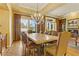 Elegant dining room with a large table, chandelier, and plenty of natural light from the windows at 308 Bayswater Ct, Las Vegas, NV 89145