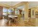 Formal dining room with large table, chandelier, and view into the living room with fireplace at 308 Bayswater Ct, Las Vegas, NV 89145