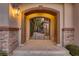 Grand entrance gate with stone pillars and intricate metalwork, leading to a beautifully landscaped courtyard at 308 Bayswater Ct, Las Vegas, NV 89145