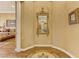 Elegant foyer featuring an ornate mirror, decorative flooring, and a glimpse of the bedroom at 308 Bayswater Ct, Las Vegas, NV 89145