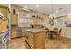 Well-equipped kitchen with stainless steel appliances, a center island, and an adjacent dining area at 308 Bayswater Ct, Las Vegas, NV 89145