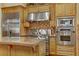 Close-up of the gourmet kitchen featuring stainless appliances, custom cabinetry, and granite countertops at 308 Bayswater Ct, Las Vegas, NV 89145