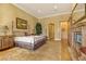 Spacious main bedroom with a fireplace, ornate furnishings, and a luxurious bed at 308 Bayswater Ct, Las Vegas, NV 89145