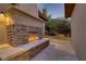 Cozy outdoor fireplace with stone surround, perfect for creating a warm and inviting atmosphere on the patio at 308 Bayswater Ct, Las Vegas, NV 89145