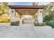 Outdoor kitchen and seating area with ceiling fan, built in grill and manicured landscaping at 308 Bayswater Ct, Las Vegas, NV 89145