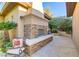 Outdoor patio space with a stone fireplace and seating area, great for entertaining at 308 Bayswater Ct, Las Vegas, NV 89145