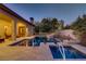 Swimming pool and spa with lush landscaping and covered patio at 308 Bayswater Ct, Las Vegas, NV 89145