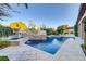 Backyard swimming pool with raised spa and a tiled waterfall feature at 308 Bayswater Ct, Las Vegas, NV 89145