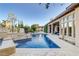 Backyard swimming pool and spa area with desert landscaping and blue skies at 308 Bayswater Ct, Las Vegas, NV 89145