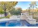 Backyard pool with tiled waterfall feature and stone retaining wall at 308 Bayswater Ct, Las Vegas, NV 89145