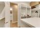 Bright walk-in closet with custom white shelving and drawers, complemented by hardwood floors and ample storage at 308 Bayswater Ct, Las Vegas, NV 89145