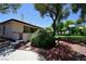 Beautiful backyard featuring manicured garden and mature shade trees with a partial view of the home at 3126 Asoleado Cir, Las Vegas, NV 89121
