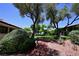 Picturesque view of a lush walkway with mature trees and verdant landscaping between homes at 3126 Asoleado Cir, Las Vegas, NV 89121