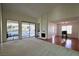 Bright living room with hardwood and carpeted floors, fireplace and view to patio at 3126 Asoleado Cir, Las Vegas, NV 89121