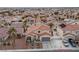 Aerial of home with a tile roof, desert landscaping, and spacious driveway, surrounded by palm trees at 319 Horse Pointe Ave, North Las Vegas, NV 89084