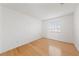 Simple bedroom with hardwood floors and a window with blinds at 319 Horse Pointe Ave, North Las Vegas, NV 89084