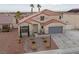 Aerial view of a charming home with a tile roof, desert landscaping, and a two-car garage at 319 Horse Pointe Ave, North Las Vegas, NV 89084