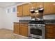 Modern kitchen with wood cabinets and tiled floor at 319 Horse Pointe Ave, North Las Vegas, NV 89084