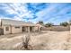 Backyard view of house with covered patio and grassy area at 320 Mindoro Ave, North Las Vegas, NV 89031