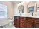 Elegant bathroom with double vanity, marble countertops, and arched mirrors at 320 Mindoro Ave, North Las Vegas, NV 89031