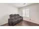 Cozy bedroom with dark herringbone floors and recliner at 320 Mindoro Ave, North Las Vegas, NV 89031