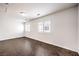 Spacious bedroom with dark herringbone floors and plantation shutters at 320 Mindoro Ave, North Las Vegas, NV 89031