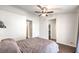 Well-lit bedroom with ceiling fan and dark herringbone floors at 320 Mindoro Ave, North Las Vegas, NV 89031